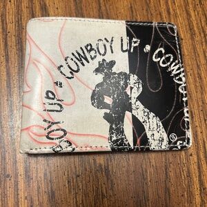 Leather cowboy billfold. Cowboy graphics and wording that says "Cowboy Up"